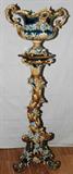 Lot# 1092 CONTINENTAL MAJOLICA JARDINIÈRE ON STAND, LATE 19TH C., H 60", Each piece features a floral, leaf and vine design in light brown and shades of blue. The double handled jardinière and base is H 17", L 24", D 15" while the stand is H 43". Unidentified hand lettered mark at the underside of the base (see additional photo).