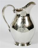 Lot# 1105 REED & BARTON STERLING WATER PITCHER, 1939, H 9 1/4", Sterling silver water pitcher with scroll handle and engraved script "ACR" monogram at one side, stamped Reed & Barton trademark at the underside with date mark indicating 1939, and number X 759. Weighs approximately 24.6 troy oz. From the Estate of Walter Connolly, Grosse Pointe Farms, Mi.