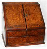 Lot# 1104 VICTORIAN BURL WALNUT SLANT-FRONT LETTER BOX WITH CALENDAR, LATE 19TH C., H 12 1/4", W 12 3/4", Slant-front doors hinge open to a perpetual calendar, slotted interior and two ink bottles, the hinged top also opens to storage. From the Estate of Walter Connolly, Grosse Pointe Farms, Mi.