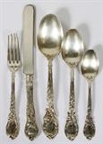 Lot# 1118 REED & BARTON 'LA PARISIENNE' STERLING FLATWARE, 44 PIECES, Sterling silver set includes 10 place knives, L.9", 9 place forks, L.7", 8 teaspoons, 11 dessert spoons, and 6 serving/table spoons, L.8"; each piece is initialed at the tip. Totaling approximately 54.15 troy oz. weighable.