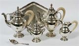 Lot# 1110 ITALIAN .800 SILVER TEA & COFFEE SET, MILAN, C. 1934-44, SIX PIECES, Neoclassical style matching set includes 1 teapot, H.10", 1 coffee pot, H.10 1/2", 1 creamer, and 1 covered sugar bowl, each piece is marked along with "800" and national mark indicating Milano, circa 1934-1944 (see additional photo). Together with 1 Italian .800 silver tea strainer, Florence, late 20th century, and 1 lozenge-form tray with ribbon and reed rim, L.17 3/4", L 10".