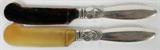 Lot# 1130 GEORG JENSEN 'CACTUS' STERLING CHEESE SPREADERS, TWO, L 6", Each having a sterling silver handle stamped "Georg Jensen" in a beaded oval, one with a light horn blade stamped "Georg Jensen Denmark", the other blade is darker and unmarked. From the Estate of Walter Connolly, Grosse Pointe Farms, Mi.