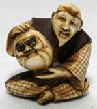 Lot# 1176 JAPANESE IVORY FIGURAL NETSUKE, SIGNED, H 1 1/2", Carved as a seated man holding a mask. From the Collection of John P. O'Hara, Bloomfield Hills, Mich.