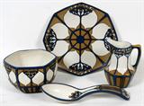 Lot# 1200 VILLEROY & BOCH, METTLACH POTTERY TEA WARE, C. 1914, FOUR PIECES, Art nouveau set incised with a stylized elder blossom pattern, decorated in blue and tan, and includes 1 bowl, H.3", Dia.4 1/2", 1 plate, Dia.7", 1 cream jug, H.4 1/2", and 1 spoon, L.7 3/4"; each piece, except the spoon, with various impressed markings, including the Old Tower trademark (1885-c, 1930), form number, decorator number, and year (see additional photo).