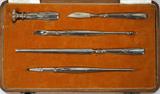 Lot# 1221 ESTONIAN/RUSSIAN .900 SILVER PRESENTATION WRITING SET, C. 1920, FIVE PIECES, ENCASED, Art deco style, including 1 seal, 1 carver/sharpener, 1 pencil, 1 letter opener, and 1 nib holder, fitted in a silk and velvet lined oak case. All pieces are stamped "900", the carver and the letter opener also stamped with the Russian kokoshnik enclosing "84" and indicating St. Petersburg.