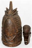 Lot# 2288 AFRICAN WOOD HELMET MASK AND ANOTHER, H 17", 7", African wood helmet mask H 17" African carved wood head 7". From the estate of Gerry Culpepper, Northville, Mi.