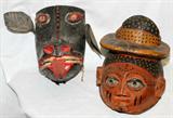 Lot# 2292 SOUTH AMERICAN CARVED WOOD MASKS TWO, H 12", Unusual boar's head with hinged mouth having leather hinge. 12". Mask in form of man's head wearing hat. From the estate of Gerry Culpepper, Northville, Mi.