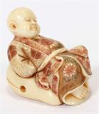 Lot# 2396 CHINESE CARVED IVORY FIGURE OF CHILD H 2", L 2". Light tint on kimono. Carved from single piece of ivory.