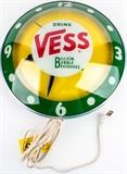 Lot #133, Advertising 'Double Bubble' Vess Billion Clock
This is a vintage advertising light-up "double bubble" (named after the two ports for adding bulbs into the piece )Backlit Clock, from "Vess", whose former slogan was "Billion Bubble Beverages." This is a piece one might have seen in a retail store, convenience store, or even bar / pub. This is the primary composition of the graphics on the piece, other than the company's colors of Yellow Green and White. Plugs in using a male A/C power plug. Appears to work, (both the light and the clock ), and is in good condition! Measures: 15" Diameter  Tagwords: intdes, interior design, wall decor, decoration, marketing, soda, pop, light up