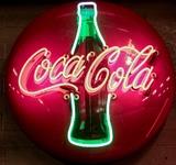 Lot #61, Vintage Coca-Cola Neon Advertising Bar Decor Sign
Awesome working neon adverting sign! Circular shaped metal red and black sign with an image of a lighted green neon Coke bottle in the center. When lit the sign has glowing red letters representing the branding for the company, reading, "Coca Cola." Perfect for your bar or man cave! Measures Approximately: 36" diameter From the internet: "Few brands have been as effectively and aggressively marketed as Coca-Cola, which was invented in 1886 by John S. Pemberton. Almost from day one, advertising materials, including signs, were produced to trumpet the virtues of the sweet, carbonated beverage. In fact, in his first year of business, Pemberton spent more money on advertising than he took in. Today, thanks in part to his early obsession with advertising, Coca-Cola is one of the best-known brand names in the world." Tag Words: Intdes, interior design, soda fountain, pop  **This item cannot be shipped**