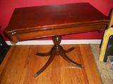 Unfolds, top swivels to make a square table.

Imperial Grand Rapids
All Mahogany
1114