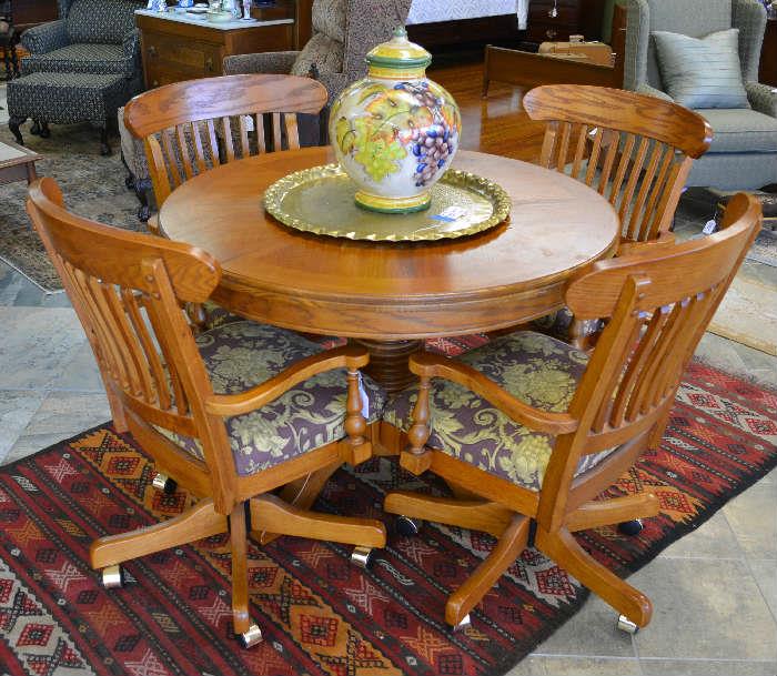very nice oak game table with 4 chairs on casters, comes with a leaf as well, large brass tray, large fruit covered urn