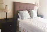 Upholstered headboard and side pieces with queen mattress and bedding