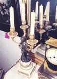 193/263  Candelabra.  A pair of 19th century French bronze and marble four arm candelabra.  A bronze figure of a putto supports the gilt bronze candelabra under each arm and is raised on a footed, square base showing ormolu floral garlands, beading and panels on three sides.
17 1/2" high
The pair:  $4500.00