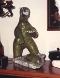 345/244 Figurine.  A contemporary Inuit soapstone carving of a bear standing over its kill, a seal on a floe.
Signed:  Eliyak Padluq
11" long x 7 3/4" deep x 13" high.  $1850.00