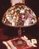 312/60  Lamp.  A 20th century American table lamp.  A cast bronze base beneath a Tiffany style, art glass domed 'tulip' shade with a beaded bronze rim.
23" high.  $1200.00