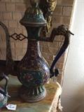 13/224  An early 20th century water pitcher in an Oriental style done in cloisonné with the finialed lid chained to the dragon head handle.
19" high:  $975.00