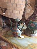 13/284  An early 20th century tea pitcher in an Oriental style done in cloisonné with finialed lid.
9 1/2" high:  $375.00