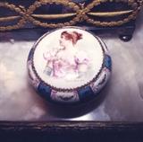 185/  Poudreuse.  A 19th century French ormolu mounted poudreuse in the Sevres manner and showing on the lid a portrait of Madame Sans-Gene.  The bowl of reserves of floral garlands on white and gold on a powder blue ground.  A Sevres reproduction by Samson Bros., of Paris.
The base shows Samson's 1878 mark along with a Capodimonte crown and 'N'.
6 3/4" in diameter X 3 3/4" high.  $125.00