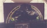 38/344  Stained glass window.  A 19th century American church window in stained glass showing Christ at prayer in the Garden of Gethsemane.  An arching glass in a rectangular wooden surround.
5' long x 3' high.  Approximate dimension due to location.  $2250.00
