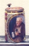 169/225  Stein.  A 19th century Austrian portrait stein.  Showing on the front, in an oval reserve, a portrait of old man holding stein.  Decorated in pale blue, white and red and raised gilded overlay.  Inscribed "Noch Eins", ['One More'].  Lift lid with portrait.
Signed:  Lamm
The base marked with the beehive mark [a copied mark of Royal Vienna] in under glazed blue, over 'Dresden' in script.
6 1/2" high.  $675.00