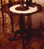 56/51  Table.  A 20th century American tilt top table with shaped applied shell and scroll piecrust rim, turned and carved post and cabriole legs with acanthus leaf carved knee and paw feet.
32" in diameter x 31 1/2" high.  $595
