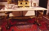 159/88  Library Table.  A large 19th century French empire style library table.  With molded marble top supported by gilded winged caryatids as legs.  The base of iron with a trestle foot.
71 1/4" long x 38 1/4" deep x 33 3/4" high.  $7000.00