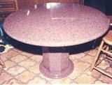 266/336  Table.  A contemporary American circular custom made red granite table raised upon an octagonal base.  Molded circular foot.
48" in diameter x 31 1/4" high.  $1800.00