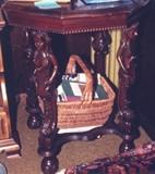 317/256  Table.  A 20th century lamp table in walnut.  A molded hexagonal top over a conforming apron with a carved, beaded rim.  The legs as carved mermaid caryatids and are separated by a molded, shaped shelf stretcher and raised on ball feet.
25 1/2" x 25 1/2" x 29 1/2" high.  $575.00