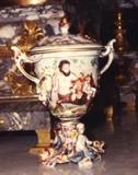 164/231  Urn.  A late 19th/early 20th century Italian Capodimonte lidded urn.  The lid with finial displays putto in low relief.  Centaurs and their young are displayed in relief about the bowl.  The stemmed, shaped base shows dolphins and mermen in high relief.  Spurred handles.
Marked with the Capodimonte 'N' and crown.
8" high.  $550.00