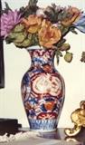 162/190  Vase.  A Japanese, Taisho period [1912-1926], Imari vase in the traditional navy blue and iron red colors on a white ground.  The base shows lappets in underglaze blue on white.  A minor chip at the base.
Unmarked.
Approximately 14" high.  $250.00