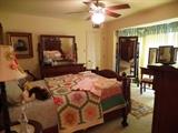 Antique guestroom with elegant furniture and quilts