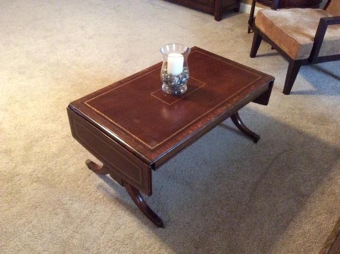 Vintage leather top mahogany drop leaf coffee table.