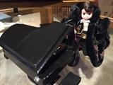 Madame Alexander "Liberace" doll with piano and storage box.