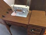 Sewing machine with cabinet