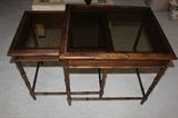 Two nesting tables with smoked glass.