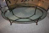 Oval glass on heavy brass coffee table.