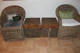 Wicker chairs and storage chests.