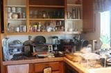 Kitchen filled with appliances, cookware, bakeware, flatware.