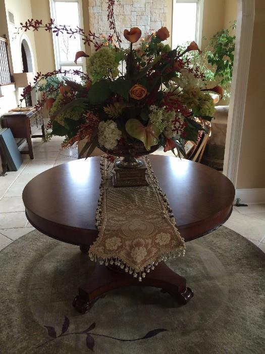 Sorry this table is not available, but the floral arrangement and carpet are