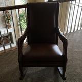 Leather rocker with swan-style frame