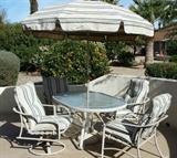 Patio table has 2 swivel rockers and 2 side chairs, umbrella and umbrella stand. 