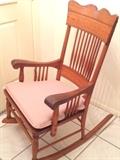 Pressback oak rocking chair with pink cushion. One of the nicest rockers we've ever had. 