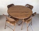 Samsonite card table has wood-grain look. 4 padded  chairs.