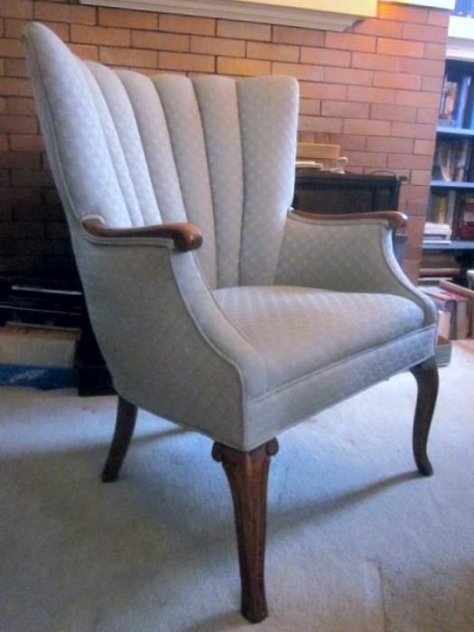 Solid, well made arm chair.  Tufted channel back, hardwood arms and legs.  Soft pale blue fabric.