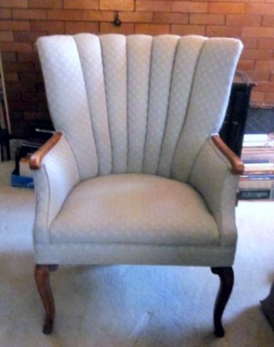 Solid, well made arm chair.  Tufted channel back, hardwood arms and legs.  Soft pale blue fabric.