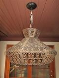 Metal scroll hanging light.  Very boho.