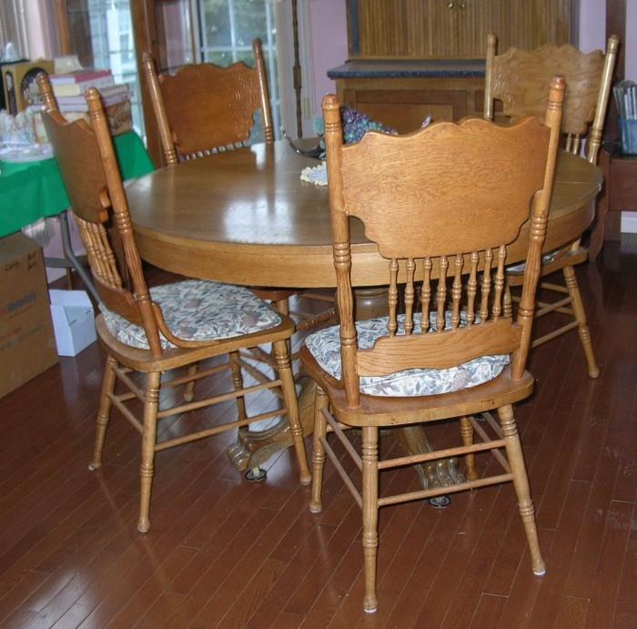 Oak pedestal table and pressed back oak chairs