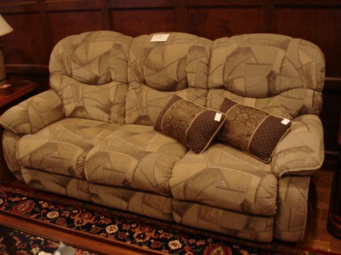 Three-person sofa with reclining seats at either end