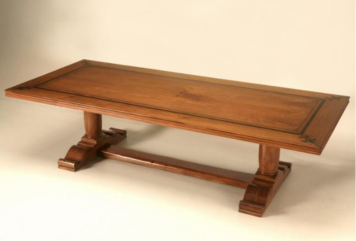 Vintage French walnut trestle dining table, with an ebonized fleur de Lys and banding. Beautifully detailed edges, a hand carved solid walnut base and a book-matched top. In order to make the grain come alive, we hand-applied an old fashion lacquer finish, which is not only crystal clear, but very durable as well, sometimes referred to as English polish. The table seats 10-12 comfortably depending on your chair width. This construction is of the highest quality, and will last for generations to come. 44" x 95"